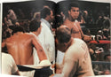 Muhammad Ali Signed Soft Cover Book (Sportscard Guaranty Authentic)